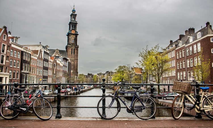 Beautiful shot of bicycles leaned again the fence on a bridge over the river
