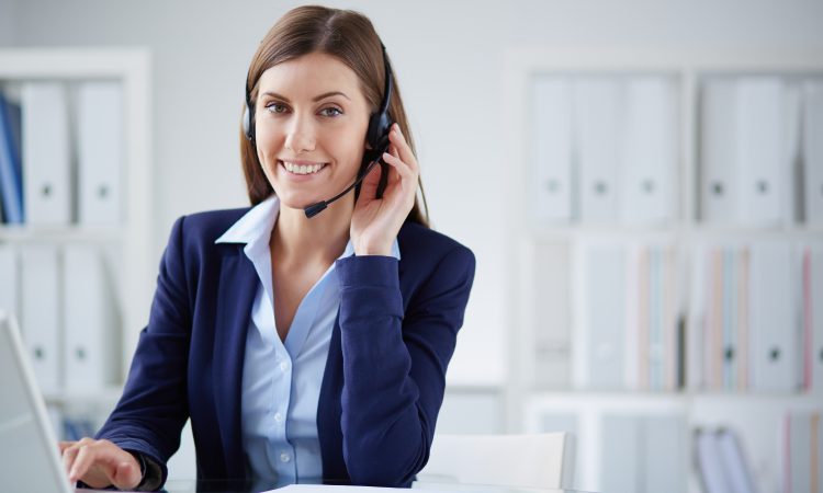 Young businesswoman with headset working in office