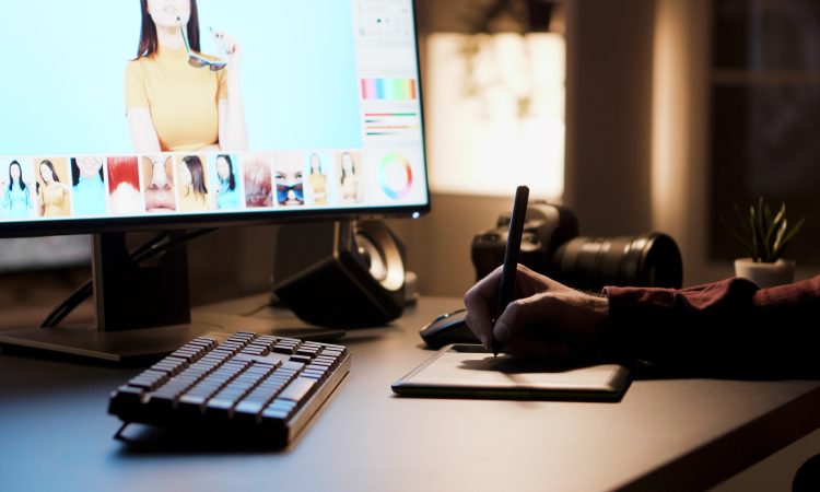 Creative photographer retouching photos at night. Retouching using digitizer.