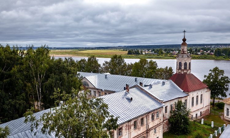 Eastern orthodox crosses on gold domes, cupolas, against blue sky with clouds. Orthodox church