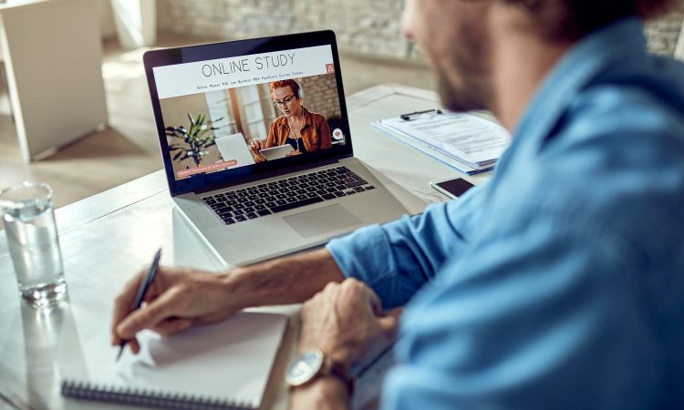 Close-up of freelancer learning online while using laptop in the office.