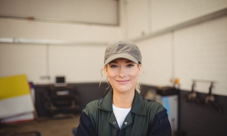 Portrait of smiling female mechanic in repair garage