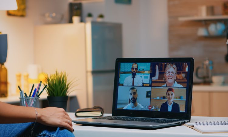 Business woman having webinar studying from home using internet technology on laptop in midnight. Lady using notebook with network wireless talking on virtual meeting at night doing overtime