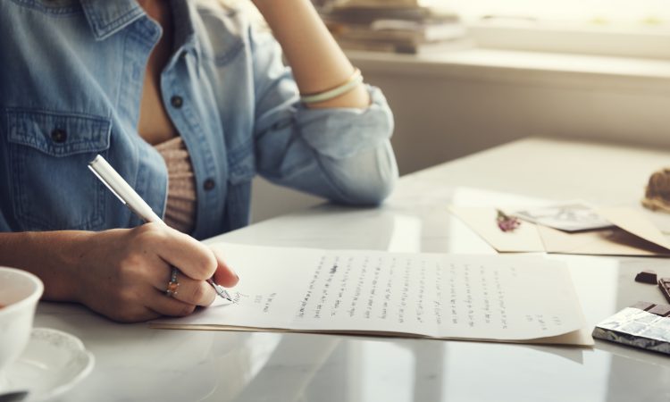 Caucasian woman writing a letter