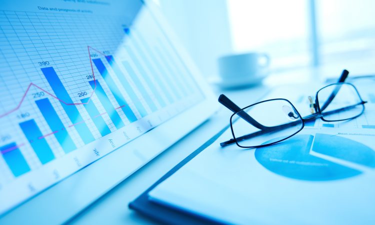 Image of workplace with paper and electronic documents and eyeglasses