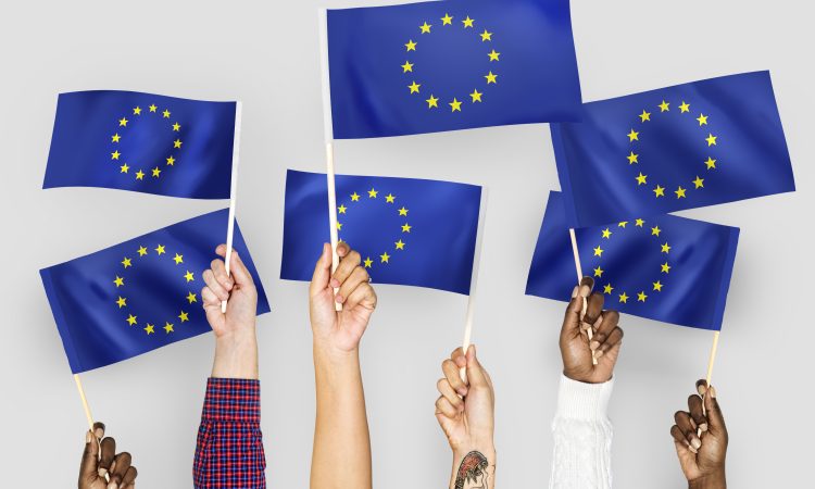 Hands waving flags of the EuropeanUnion